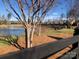 Scenic pond with a black fence outlining the yard and beautiful homes in the background at 1220 Avalon Pl, Matthews, NC 28104