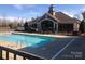 Community pool with clear blue water and a clubhouse in the background at 1220 Avalon Pl, Matthews, NC 28104