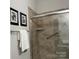 This tiled walk-in shower features grab bars and a glass door at 1220 Avalon Pl, Matthews, NC 28104