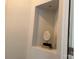 Decorative wall niche with recessed lighting, display books, and spiral-shaped decorative statue at 1220 Avalon Pl, Matthews, NC 28104