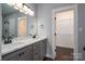 Bathroom with double vanity, marble countertops, and a walk-in closet at 1282 Beal Rd, Lincolnton, NC 28092