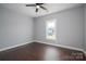 This is a light and airy bedroom with dark vinyl floors and a ceiling fan at 1282 Beal Rd, Lincolnton, NC 28092