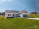 New construction featuring an inviting open garage, lush simulated lawn, and a charming exterior at 1282 Beal Rd, Lincolnton, NC 28092