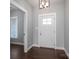 A foyer featuring a white door with glass panes and dark wood floors at 1282 Beal Rd, Lincolnton, NC 28092