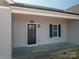 A front porch with a black door with sidelight and a single window with black shutters at 1282 Beal Rd, Lincolnton, NC 28092