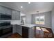 Open concept kitchen with gray cabinets, stainless steel appliances, and adjacent dining area at 1282 Beal Rd, Lincolnton, NC 28092