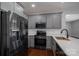 Modern kitchen featuring gray cabinets, stainless steel appliances, and white subway tile backsplash at 1282 Beal Rd, Lincolnton, NC 28092