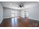 A living room with grey walls, dark trim, a ceiling fan, and a back door at 1282 Beal Rd, Lincolnton, NC 28092