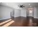 A living room featuring a ceiling fan, grey walls, dark trim and dark floors at 1282 Beal Rd, Lincolnton, NC 28092