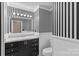 Charming bathroom with black and white striped wallpaper and ample vanity storage at 130 Ketchie Dr, Mooresville, NC 28115