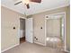 Bedroom features a ceiling fan, mirrored closet doors, and neutral carpet flooring at 130 Ketchie Dr, Mooresville, NC 28115