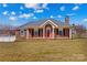 Charming one-story brick home with a welcoming red front door and well-maintained lawn at 130 Ketchie Dr, Mooresville, NC 28115