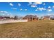 A single story brick home with a red door and black shutters, surrounded by a well-maintained lawn and white picket fence at 130 Ketchie Dr, Mooresville, NC 28115