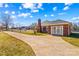Exterior front elevation featuring large driveway and partial brick facade at 130 Ketchie Dr, Mooresville, NC 28115
