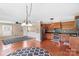 Open kitchen boasts stainless steel appliances, wood cabinets, and decorative light fixtures at 130 Ketchie Dr, Mooresville, NC 28115