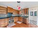 Bright kitchen with stainless appliances, wood cabinets, tiled backsplash, and convenient pantry access at 130 Ketchie Dr, Mooresville, NC 28115