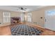 Well-lit living room featuring a brick fireplace, hardwood floors, and large windows at 130 Ketchie Dr, Mooresville, NC 28115