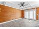 This sun-filled living room features wood walls, coffered ceiling, and luxury vinyl floors at 130 Ketchie Dr, Mooresville, NC 28115