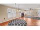 Spacious living room with hardwood floors, large windows, and a cozy fireplace at 130 Ketchie Dr, Mooresville, NC 28115