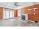 Cozy living room features a fireplace, wood walls, and large windows for natural light at 130 Ketchie Dr, Mooresville, NC 28115