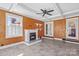 Charming living room with fireplace, wood accent wall, luxury vinyl floors and lots of natural light at 130 Ketchie Dr, Mooresville, NC 28115