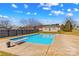 Backyard pool with a diving board on a sunny day and a shed nearby at 130 Ketchie Dr, Mooresville, NC 28115
