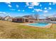 Outdoor pool with diving board and concrete features metal ladder access and is next to the screened in porch at 130 Ketchie Dr, Mooresville, NC 28115