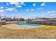 Outdoor pool with concrete surround and diving board features metal ladder access and is fully fenced at 130 Ketchie Dr, Mooresville, NC 28115