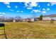 Large yard with chain link fence surrounding the property and a storage shed at 130 Ketchie Dr, Mooresville, NC 28115