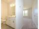 Bathroom featuring a neutral palette, double vanity and an open view of the bedroom at 1307 Cerium Way, Charlotte, NC 28211