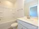 Bright bathroom with a shower-tub combo, white vanity and ample lighting at 1307 Cerium Way, Charlotte, NC 28211