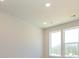 Well-lit bedroom with two large windows offering views of lush greenery at 1307 Cerium Way, Charlotte, NC 28211