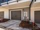 Two-car garage with brown doors on a modern townhome with gray and white siding at 1307 Cerium Way, Charlotte, NC 28211