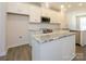 A modern kitchen features white cabinets, stainless steel appliances, marble countertops, and wood-look flooring at 1307 Cerium Way, Charlotte, NC 28211
