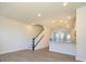 Open concept living space with view of staircase and kitchen area at 1307 Cerium Way, Charlotte, NC 28211