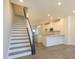 View of the kitchen from the living room shows the modern staircase at 1307 Cerium Way, Charlotte, NC 28211