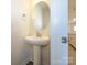 Powder room featuring a pedestal sink and an oval mirror at 1307 Cerium Way, Charlotte, NC 28211