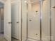 Bathroom featuring a glass door shower and view of a closet space at 1307 Cerium Way, Charlotte, NC 28211