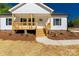Close up of the front porch, featuring natural wood steps and charming details at 1311 Mack Dr, McConnells, SC 29726