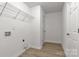 Clean laundry room with shelving, washer hookups, and wood-look flooring at 1311 Mack Dr, McConnells, SC 29726