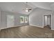 Open-concept living room featuring wood-look flooring, vaulted ceiling and ample natural light at 1311 Mack Dr, McConnells, SC 29726