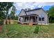 Charming home featuring a covered deck with a spacious backyard and lush landscaping at 144 Sardis Ln, Charlotte, NC 28270