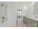 Bright, dual sink bathroom featuring tiled floors, a tub-shower combo and natural lighting at 144 Sardis Ln, Charlotte, NC 28270