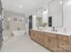 Luxurious bathroom featuring a soaking tub, a walk-in shower, and double vanity with modern fixtures at 144 Sardis Ln, Charlotte, NC 28270