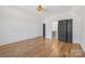 Bright bedroom featuring hardwood floors, natural light, neutral walls, and an ensuite entrance at 144 Sardis Ln, Charlotte, NC 28270
