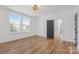 Bright bedroom featuring hardwood floors, natural light, neutral walls, and an ensuite entrance at 144 Sardis Ln, Charlotte, NC 28270