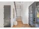 Inviting entryway with hardwood floors, contemporary decor, and staircase leading to the upper level at 144 Sardis Ln, Charlotte, NC 28270