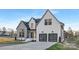 Stunning two-story home with painted brick, two-car garage, modern lighting, and manicured landscaping at 144 Sardis Ln, Charlotte, NC 28270