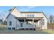 Rear exterior of home featuring a covered porch and well maintained lawn at 144 Sardis Ln, Charlotte, NC 28270