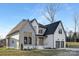 Charming two-story home with a well-manicured lawn, and a three-car garage showcasing modern architecture at 144 Sardis Ln, Charlotte, NC 28270